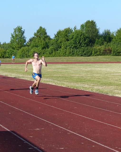 Runner pushing through a grueling sprint on a track, showcasing determination and endurance.
